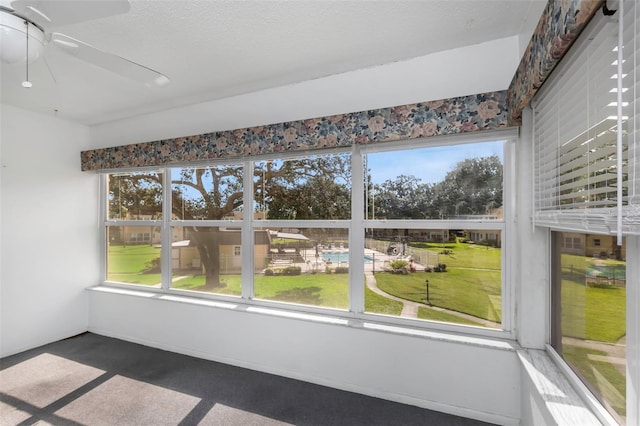 interior space featuring a healthy amount of sunlight and ceiling fan