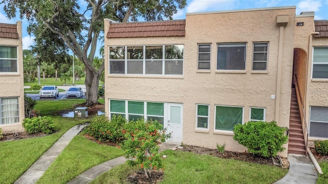 view of property featuring a front lawn