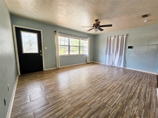 foyer entrance featuring a textured ceiling, ceiling fan, and hardwood / wood-style flooring