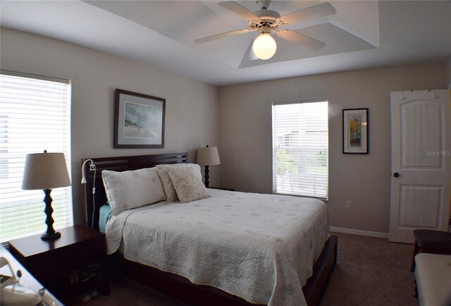 bedroom featuring ceiling fan and dark colored carpet