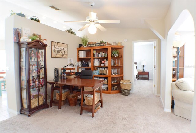 home office featuring light colored carpet, lofted ceiling, and ceiling fan