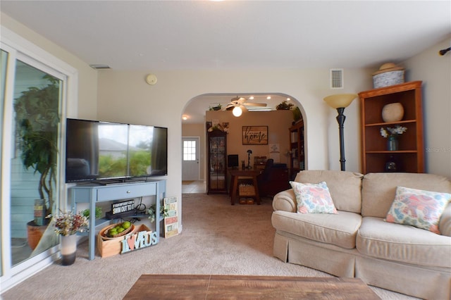 living room with ceiling fan and carpet floors