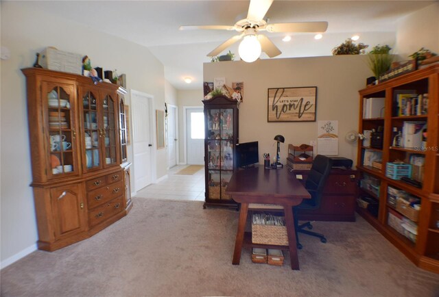 carpeted office space featuring vaulted ceiling and ceiling fan