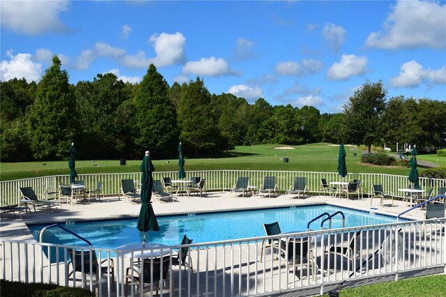 view of swimming pool with a lawn and a patio area