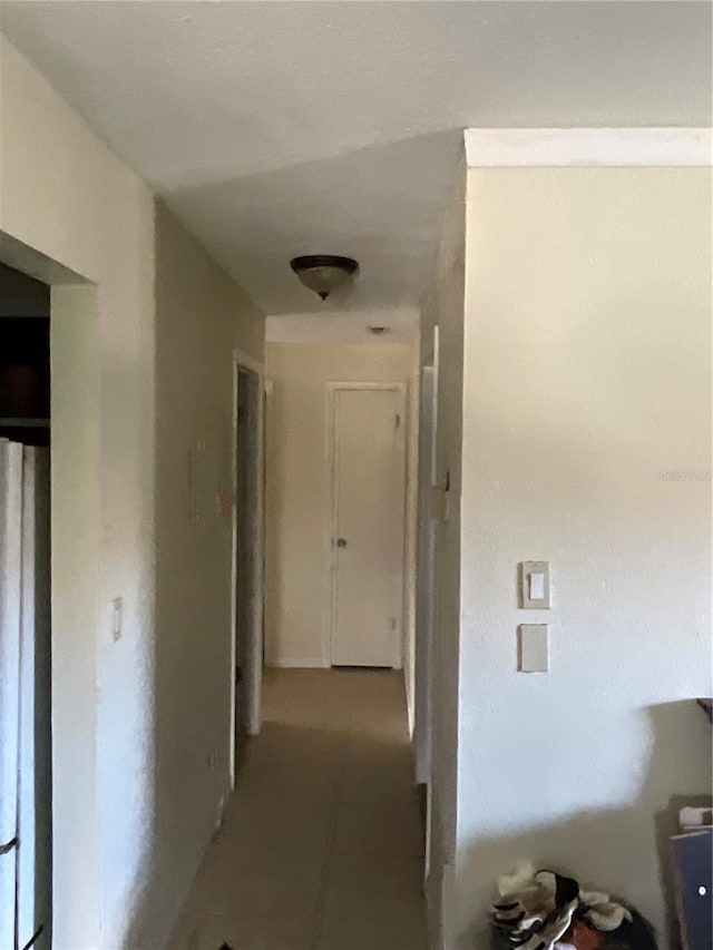 hallway featuring tile patterned flooring