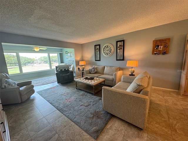 tiled living room with ceiling fan and a textured ceiling