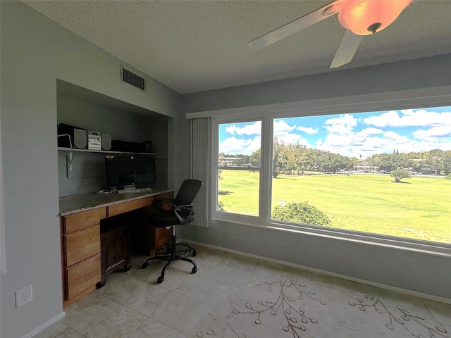 office area featuring ceiling fan and a textured ceiling