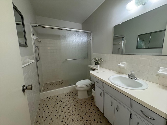 bathroom featuring a shower with door, vanity, toilet, decorative backsplash, and tile patterned floors