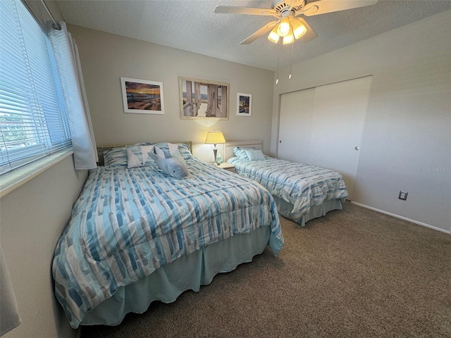 bedroom with a closet, a textured ceiling, ceiling fan, and carpet