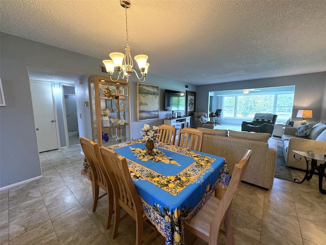 dining space with tile patterned floors, a notable chandelier, and a textured ceiling