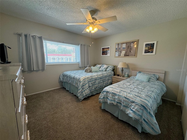 carpeted bedroom featuring a textured ceiling and ceiling fan