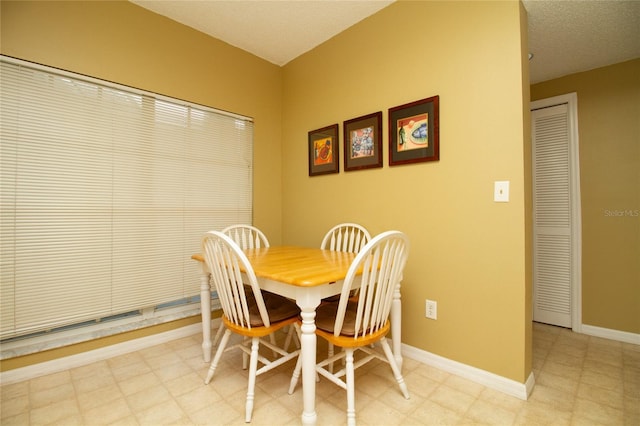 dining area featuring a textured ceiling