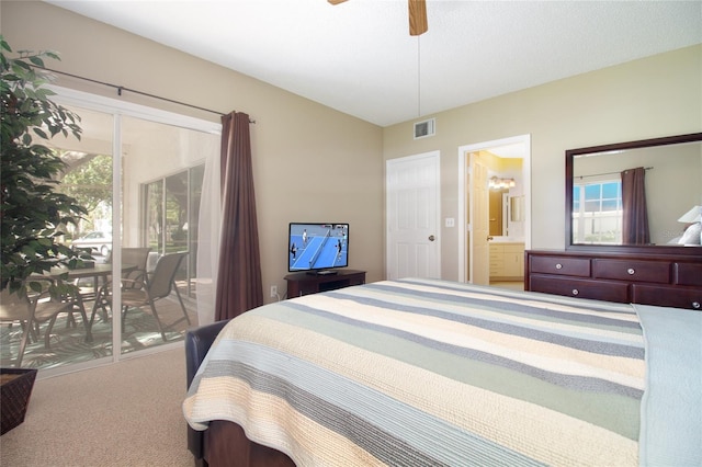 carpeted bedroom featuring ceiling fan, ensuite bathroom, and access to exterior