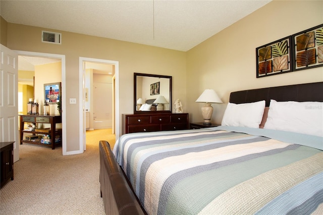 carpeted bedroom with ensuite bath