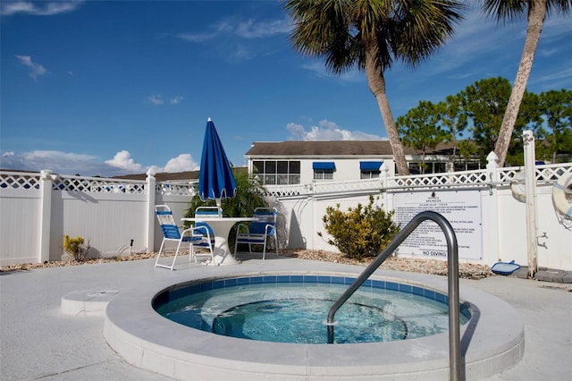 view of swimming pool featuring a patio and a community hot tub