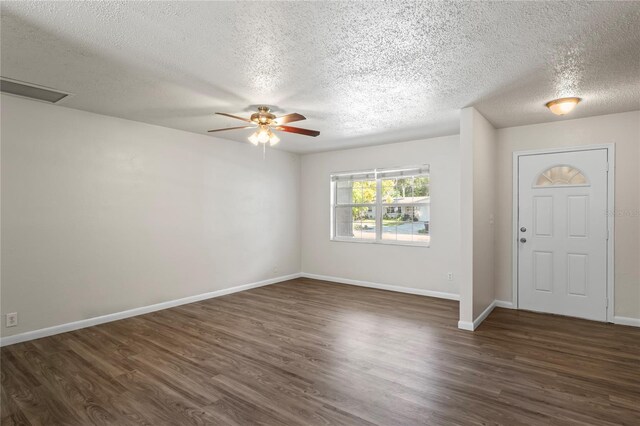 foyer with ceiling fan, dark hardwood / wood-style floors, and a textured ceiling