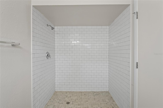 bathroom with tiled shower