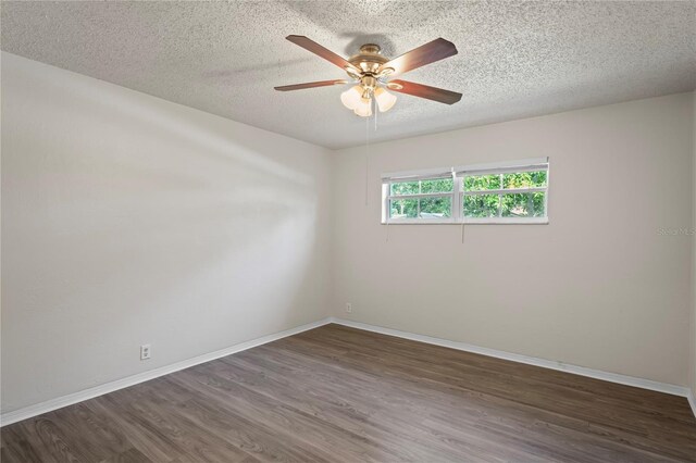 unfurnished room featuring dark wood-type flooring, a textured ceiling, and ceiling fan