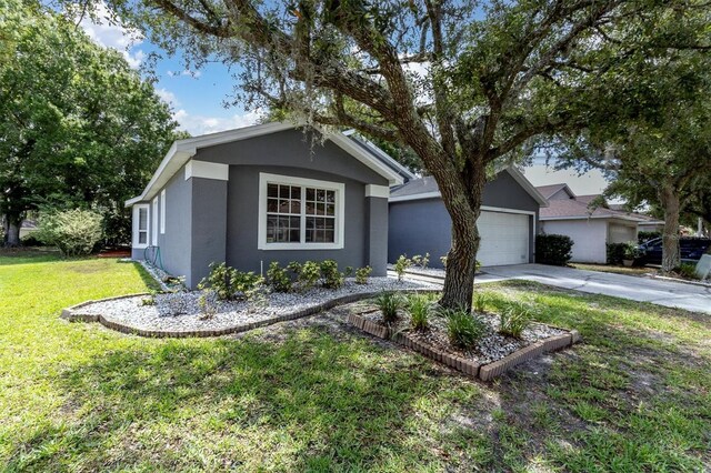 single story home with a garage and a front lawn