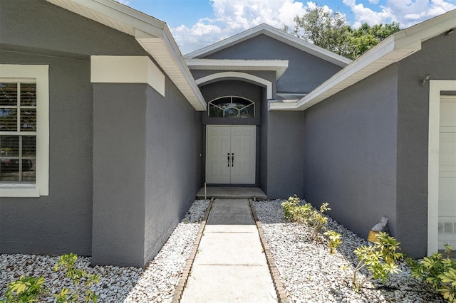 doorway to property with stucco siding