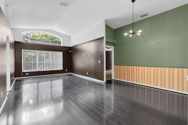 unfurnished room featuring vaulted ceiling, wood finished floors, visible vents, and a notable chandelier