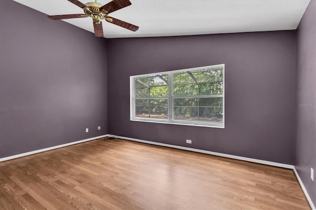 unfurnished room featuring ceiling fan, baseboards, and wood finished floors