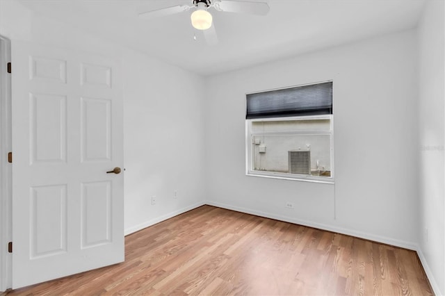 empty room featuring ceiling fan, wood finished floors, and baseboards