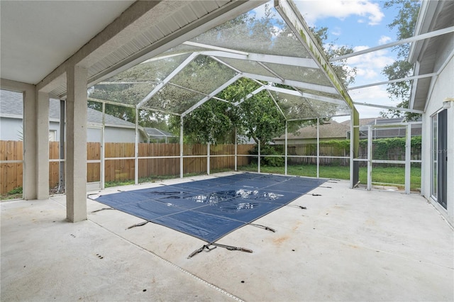 view of swimming pool with glass enclosure and a patio area