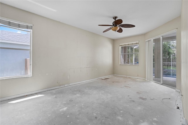 empty room featuring ceiling fan and concrete floors