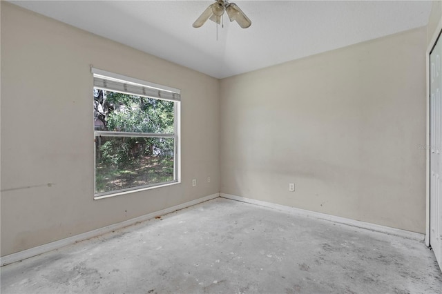 spare room with concrete floors and ceiling fan