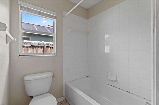 bathroom featuring toilet and tiled shower / bath combo