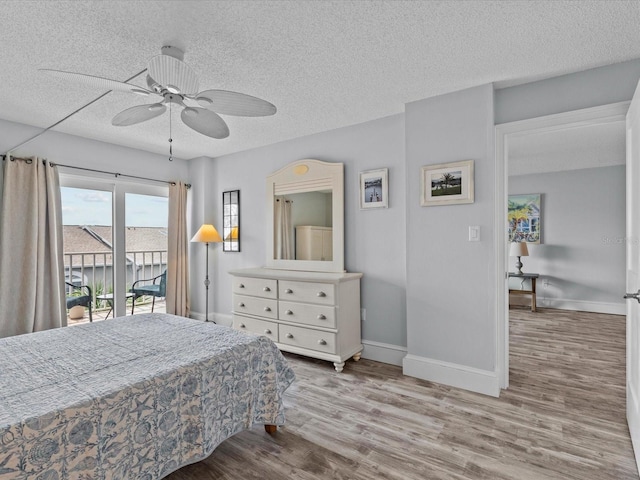 bedroom featuring light wood-type flooring, a textured ceiling, access to exterior, and ceiling fan