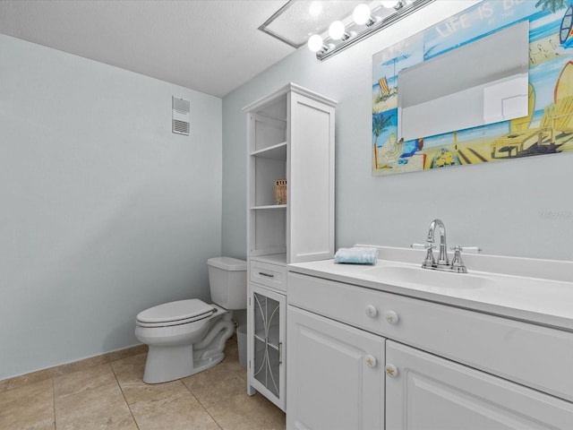 bathroom featuring tile patterned flooring, toilet, and vanity