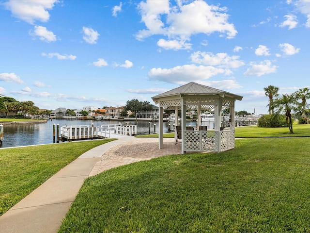 dock area featuring a gazebo, a yard, and a water view