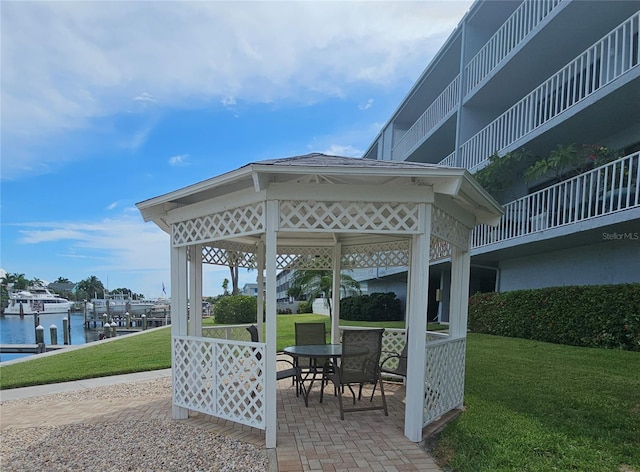 surrounding community featuring a water view, a lawn, a patio area, and a gazebo