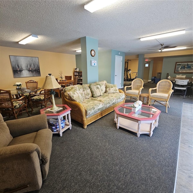 carpeted living room with a textured ceiling and ceiling fan