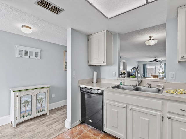 kitchen with black dishwasher, sink, white cabinetry, ceiling fan, and light wood-type flooring