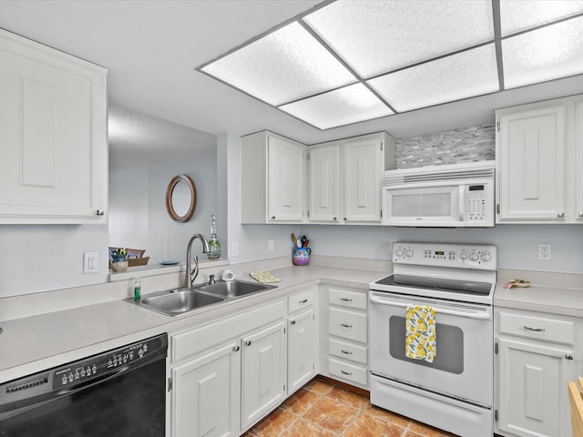 kitchen featuring sink, white appliances, and white cabinets