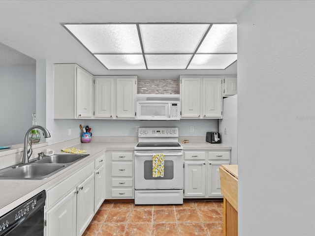 kitchen with white appliances, white cabinetry, and sink