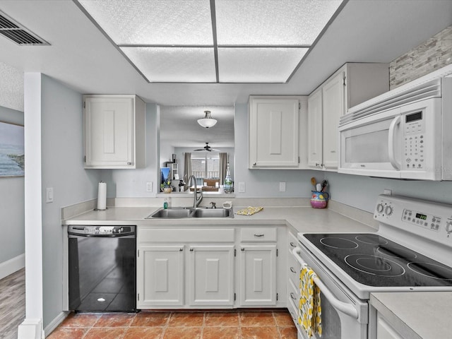 kitchen with white appliances and white cabinetry