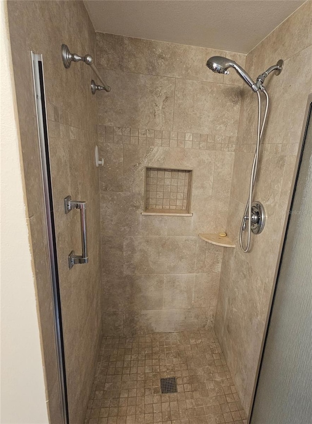 bathroom featuring a shower with shower door