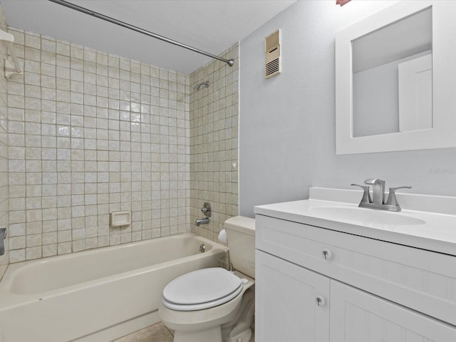 full bathroom with toilet, tiled shower / bath combo, and vanity