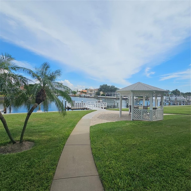 view of home's community with a water view, a yard, and a gazebo