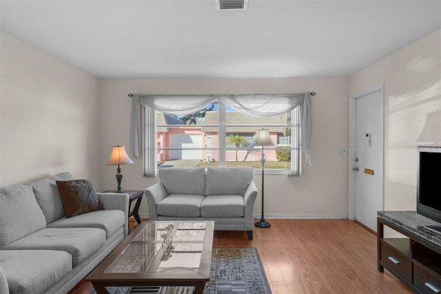 living room featuring plenty of natural light and light wood-type flooring