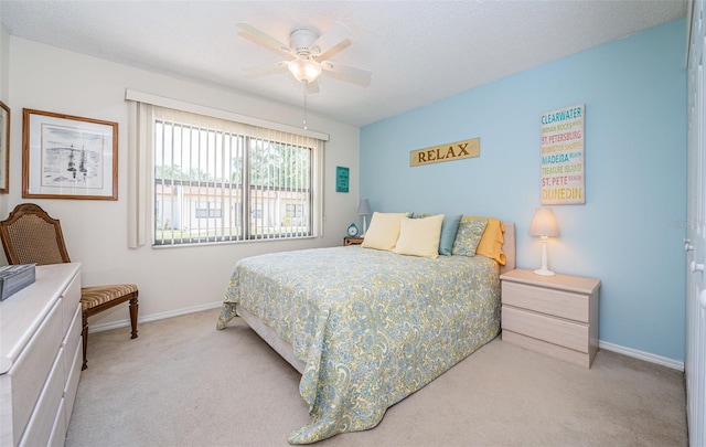 bedroom featuring ceiling fan and light carpet