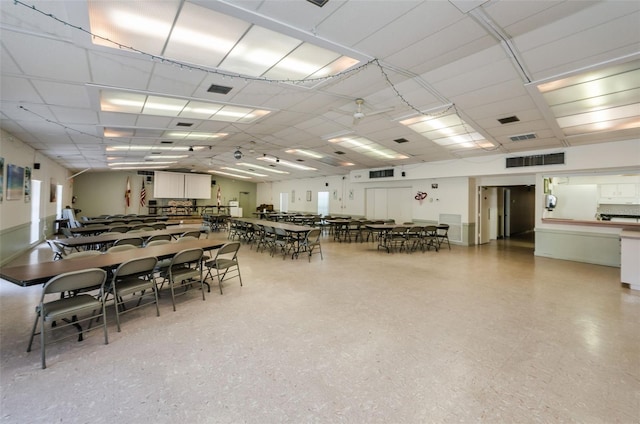 dining space with visible vents and a drop ceiling