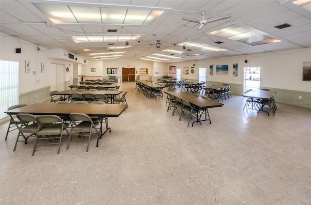 dining room featuring visible vents, ceiling fan, and a drop ceiling