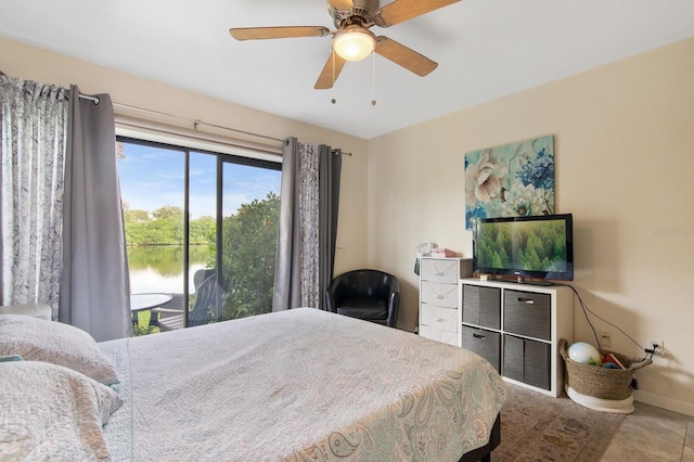 tiled bedroom with ceiling fan and access to exterior