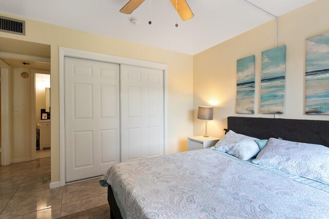 bedroom with ceiling fan, a closet, and tile patterned flooring