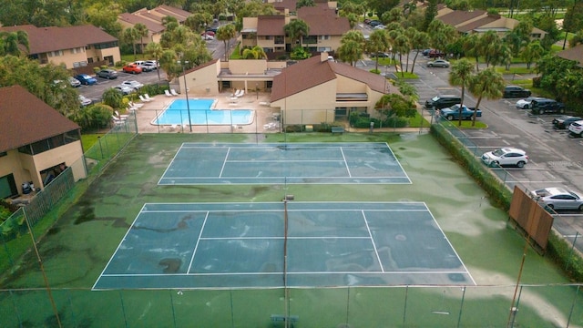 view of sport court with a community pool